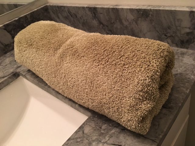 Roll up in the towel and press to remove as much moisture as possible